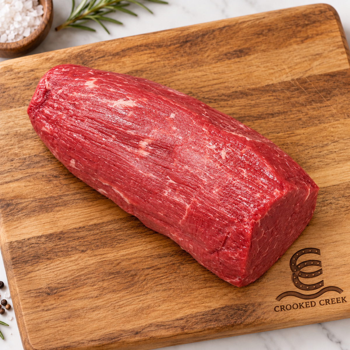 Eye of round roast on a Crooked Creek branded wooden cutting board